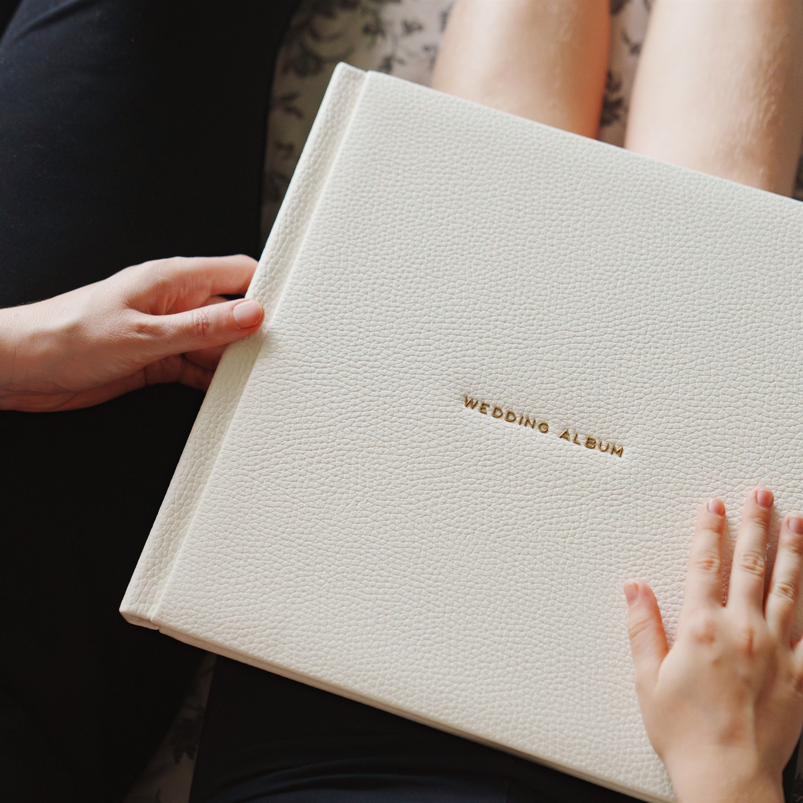 Hands turning the pages of a family photo album